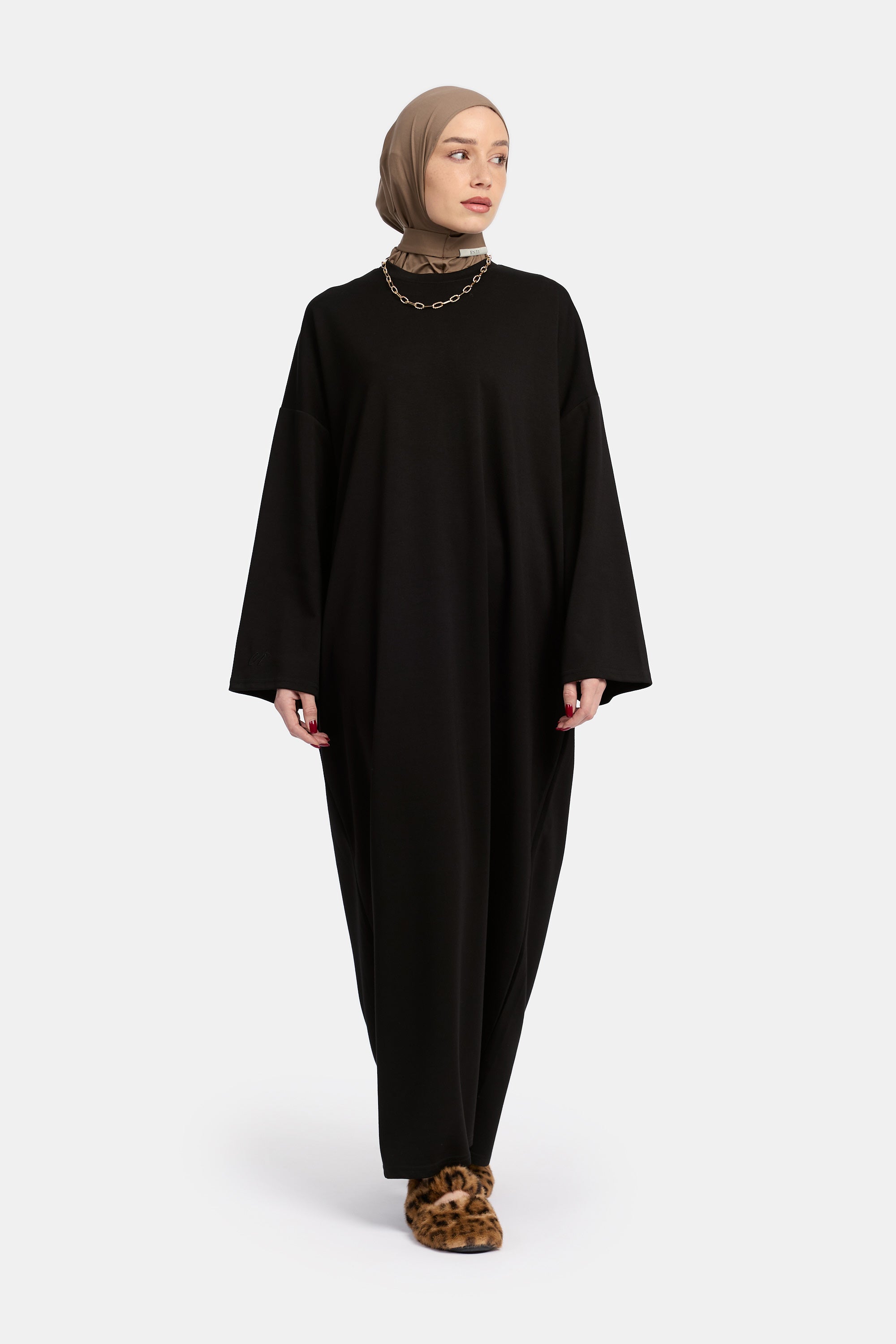 voor aanzicht van model die draagt Wide Sleeve Dress van het modest merk ENTI in de kleur zwart
